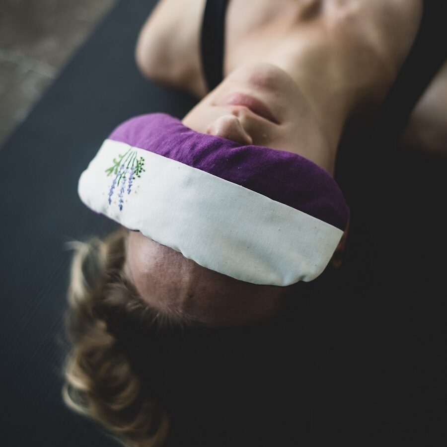 woman put purple and white pad on her forehead